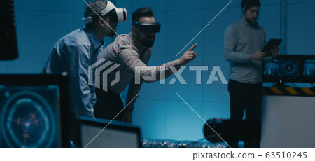 Engineers using VR glasses in workplace Engineers using VR glasses in workplace 63510245