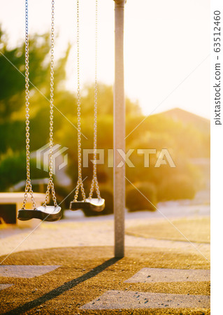 Children's swings on the chain in the park  63512460