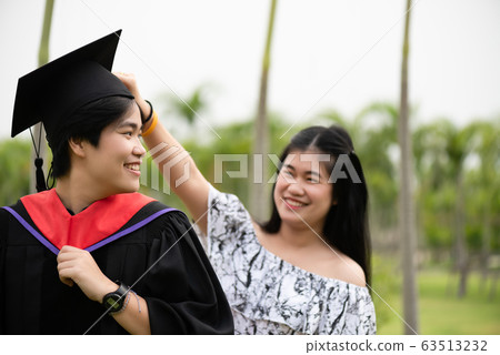 Graduation ceremony. Young female graduate with Graduation ceremony. Young female graduate with 63513232