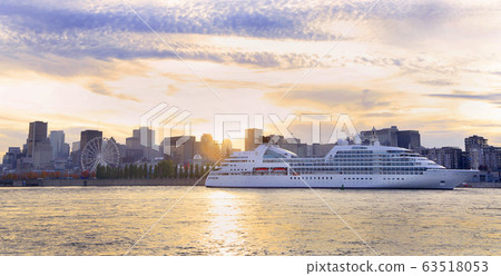 Cruise boat sailing at sunset on St. Lawrence River with skyline of Montreal on the background, Canada Cruise boat sailing at sunset on St. Lawrence River with skyline of Montreal on the background, Canada 63518053