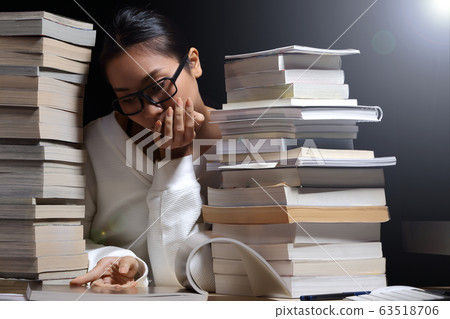 Girl in white shirt reading many textbooks on Girl in white shirt reading many textbooks on 63518706