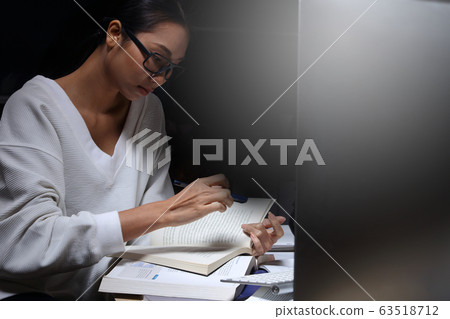 Girl in white shirt reading many textbooks on Girl in white shirt reading many textbooks on 63518712
