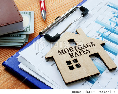 Mortgage rates sign on the home and charts. Mortgage rates sign on the home and charts. 63527118