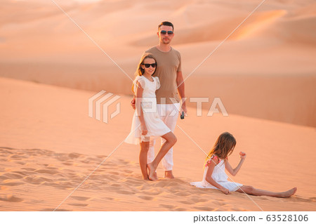 People among dunes in desert in United Arab Emirates People among dunes in desert in United Arab Emirates 63528106