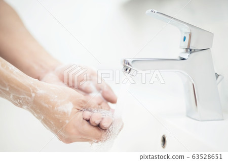 Men are washing their hands every time before eating 63528651