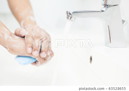 Men are washing their hands every time before eating Men are washing their hands every time before eating 63528655