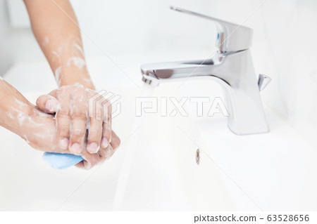 Men are washing their hands every time before eating Men are washing their hands every time before eating 63528656