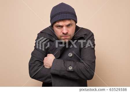 Young caucasian speculator man gangster or bandit Young caucasian speculator man gangster or bandit 63529386