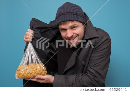 Smuggler selling food. Dealer in hat and coat 63529441