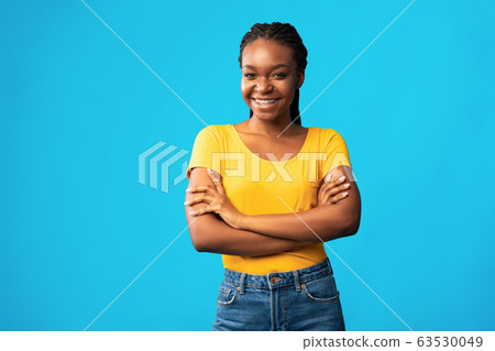 Confident Black Girl Smiling Crossing Hands Posing On Blue Background 63530049