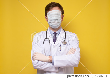 A portrait of a physician posing with a face mask A portrait of a physician posing with a face mask 63530231