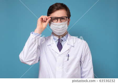 Physician or doctor posing with a face mask Physician or doctor posing with a face mask 63530232