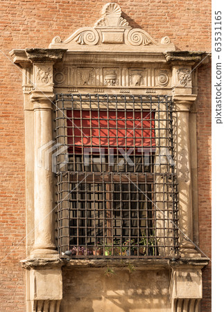 Ancient window with metal grate in Bologna Italy - Accursio Palace 63531165