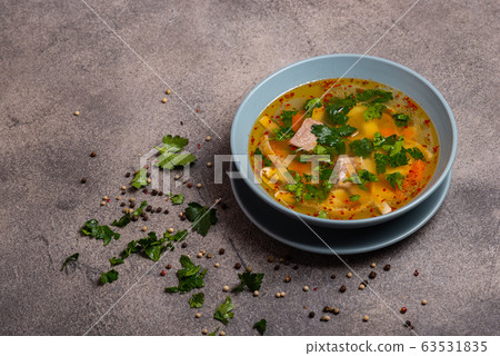 Delicious spicy soup with beef and noodle on grey background. Copy space for text. Delicious spicy soup with beef and noodle on grey background. Copy space for text. 63531835