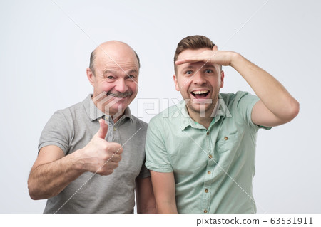 Excited caucasian men father and son are surprised 63531911
