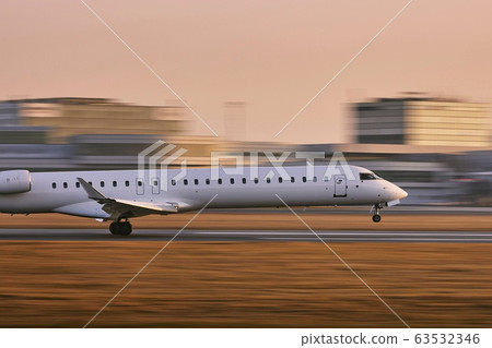 Airplane landing at golden sunset 63532346