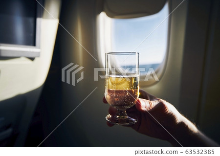 Glass of sparkling wine during flight 63532385