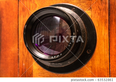 lens on an old wooden camera lens on an old wooden camera 63532861