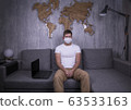 man in quarantine for Coronavirus wearing protective medical mask and smart working at home 63533163