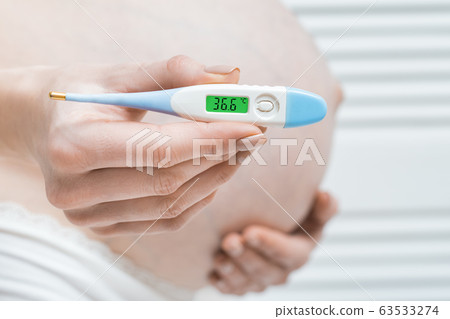 Medical thermometer with temperature 36,6 against 63533274