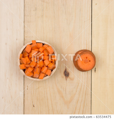 carrots slice on wooden background carrots slice on wooden background 63534475