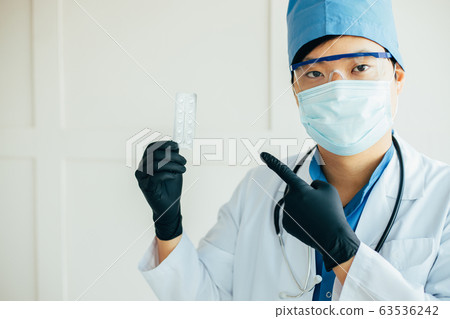 Medicine and medication. Asian doctor with pills Medicine and medication. Asian doctor with pills 63536242
