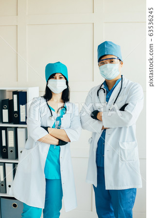 Asian doctors in medical face masks and uniform 63536245