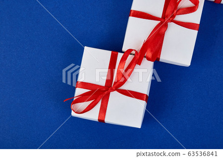Luxury white gift boxes with red ribbon Luxury white gift boxes with red ribbon 63536841