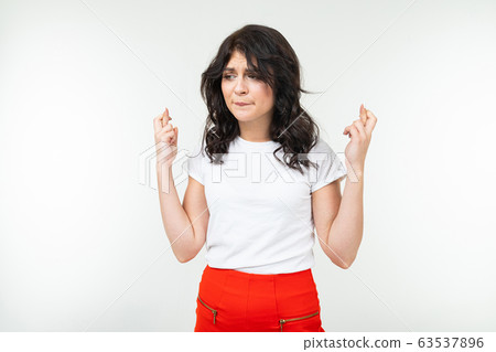 brunette girl in a white t-shirt worries on a white background 63537896