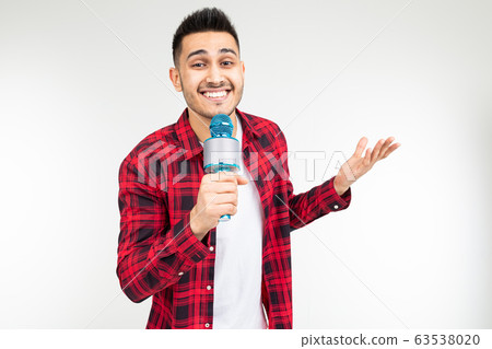 performer guy singer in a shirt with a microphone in his hands on a white background 63538020