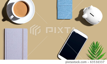 Smartphone with a piggy bank and notebooks Smartphone with a piggy bank and notebooks 63538337