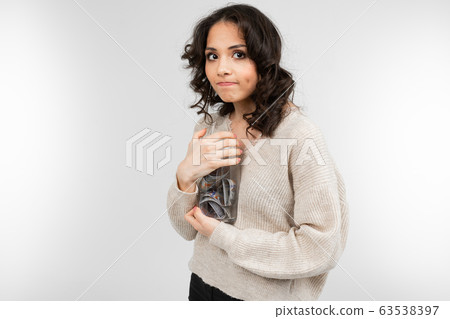 girl dreams of spending her money from a piggy bank on a white background girl dreams of spending her money from a piggy bank on a white background 63538397