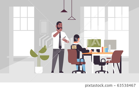sticky note with text kick me on back of businessman april fools day concept african american man glues sticker inscription to coworker modern office interior full length horizontal 63538467