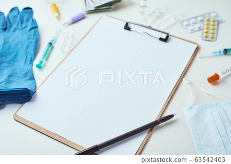 Top view of medical items and empty paper blank 63542403