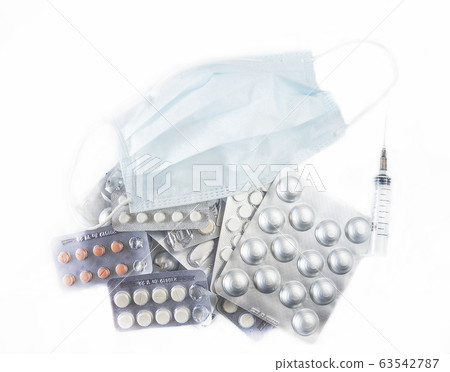Surgical mask, syringe and many tablets isolated Surgical mask, syringe and many tablets isolated 63542787