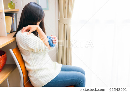 Woman cooling ice sack on arm Woman cooling ice sack on arm 63542991