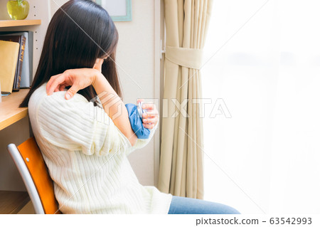 Woman applying ice sac to elbow cold compress icing cooling Woman applying ice sac to elbow cold compress icing cooling 63542993