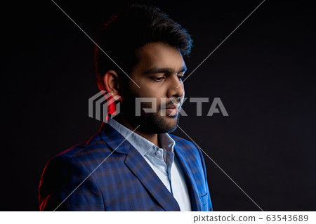 Indian young businessman on dark background 63543689