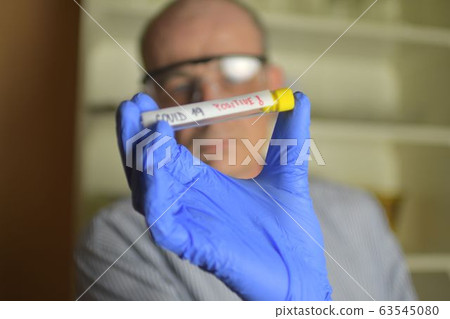 Doctor holds COVID 19 Coronavirus vaccine in his hand, infected sample in the sample tube, Vaccine and syringe injection It use for prevention, immunization and treatment from COVID-19. Doctor holds COVID 19 Coronavirus vaccine in his hand, infected sample in the sample tube, Vaccine and syringe injection It use for prevention, immunization and treatment from COVID-19. 63545080