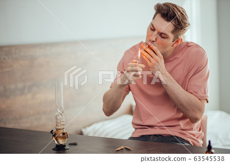 man lighting cannabis weed, going to catch a buzz 63545538