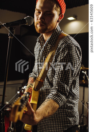 talented musician play on electric guitar his favourite song 63545609