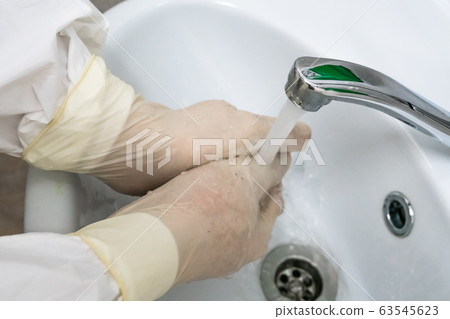 Surgeon washes and processes hands with rubber 63545623