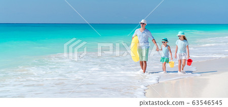Happy beautiful family on a tropical beach vacation Happy beautiful family on a tropical beach vacation 63546545