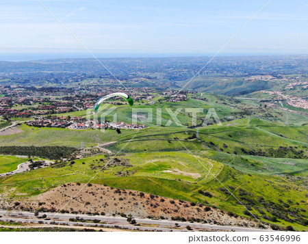 Para-glider over the top of the mountain during summer sunny day Para-glider over the top of the mountain during summer sunny day 63546996