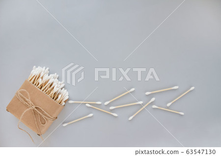 Bamboo cotton sticks in paper box bound with flax or hemp cord on grey background. Copy space, mockup, eco friendly concept 63547130