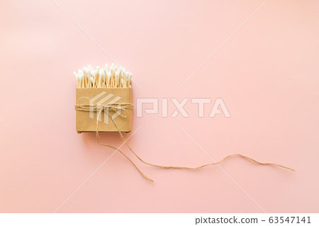 Bamboo cotton sticks in paper box bound with flax or hemp cord on pink background. Copy space, eco friendly concept 63547141