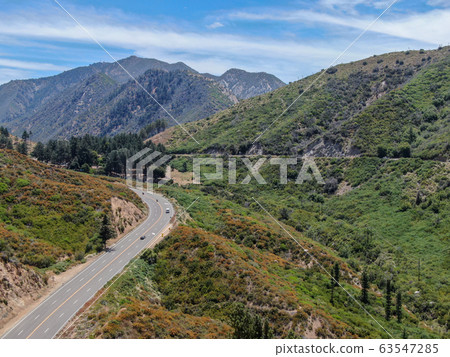 Asphalt road bends through Angeles National forests mountain, California, USA. Asphalt road bends through Angeles National forests mountain, California, USA. 63547285