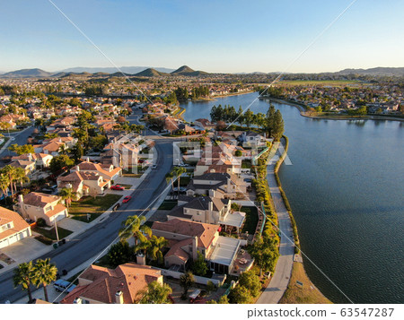 Aerial view of Menifee Lake and neighborhood, residential subdivision vila during sunset. 63547287