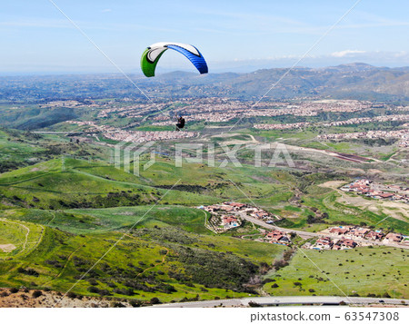 Para-glider over the top of the mountain during summer sunny day 63547308