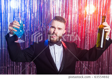 Alcoholism, fun and fool concept - Drunk man at party in a nightclub. 63554692
